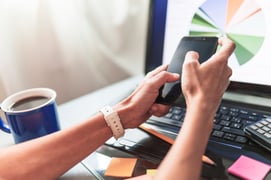 crop-hands-using-smartphone-office